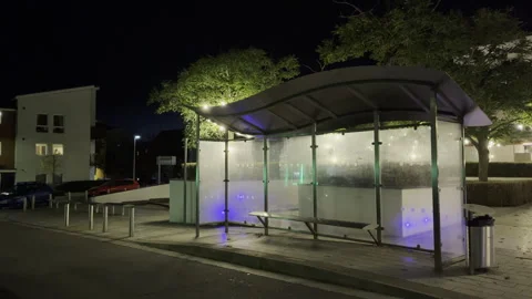 Large city empty bus stop at night in England Stock Footage 253637672