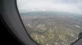 Large city seen through window of plane flying high in sky, air travel service 4k or 4k+ Resolution