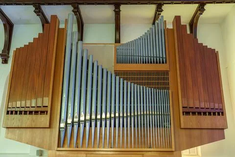 A large classical organ inside the Catholic Church.  A keyboard wind musical  Stock Photos