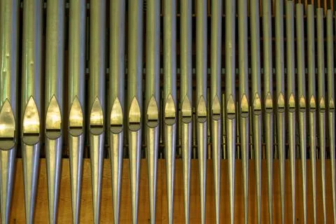 A large classical organ inside the Catholic Church.  A keyboard wind musical  Stock Photos