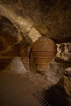 Large clay amphorae in historic underground storage cave Stock Photos