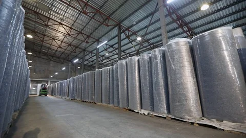 Large clean light warehouse in a factory, warehouse with rolls of products Stock Footage 118915361