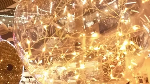 Large, clear, gold colored sphere with a string of lights inside Stock Footage 313286436