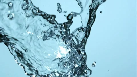 Large clear water splashes on blue background Stock Footage 327179680