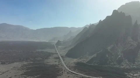 Large cliffs in a desert sandy rough rock landscape. Road running thorugh the 스톡 동영상 170702940