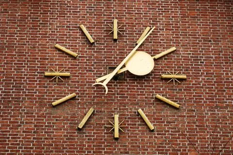 A large clock on the brick wall Stock Photos