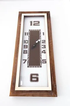 A large clock mounted on a white wall Stock Photos