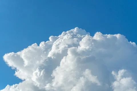 Large cloud on clear blue sky background with copy space for wallpaper. Stock Photos