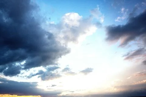 Large cloud formation is dominating flat vector sky illustration, with glowing Stock Photos