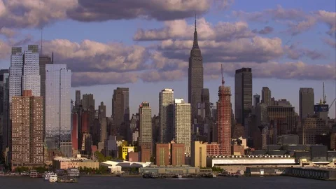 Large clouds above Midtown Manhattan skyline slowly cast shadows over the city. Stock Footage 78797424