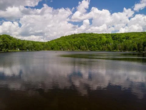 Large clouds over a small lake Stock Photos