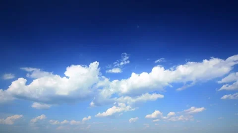 Large clouds slowly move together on blue sky day time lapse. Stockbeeldmateriaal 8408531