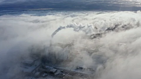 Large clouds of white smoke cover power plant territory Stock Footage 129728511