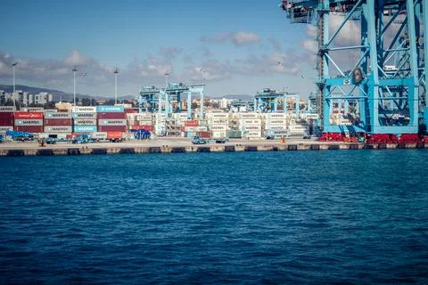Large CMA CGM container ship unloading cargo under gantry cranes at port of.. Stock Photos