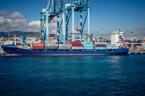 Large CMA CGM container ship unloading cargo under gantry cranes at port of.. 스톡 사진