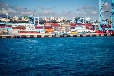 Large CMA CGM container ship unloading cargo under gantry cranes at port of.. Stock Photos