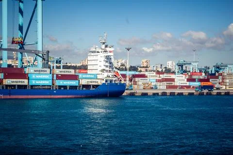 Large CMA CGM container ship unloading cargo under gantry cranes at port of.. Stock Photos
