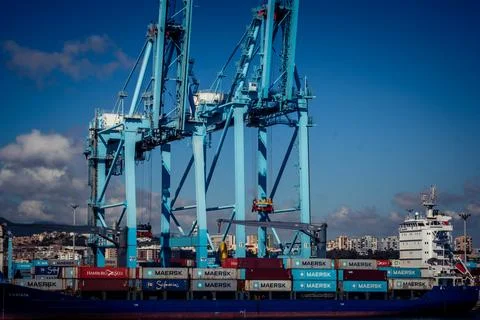 Large CMA CGM container ship unloading cargo under gantry cranes at port of.. Stock Photos
