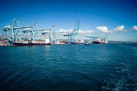 Large CMA CGM container ship unloading cargo under gantry cranes at port of.. 스톡 사진