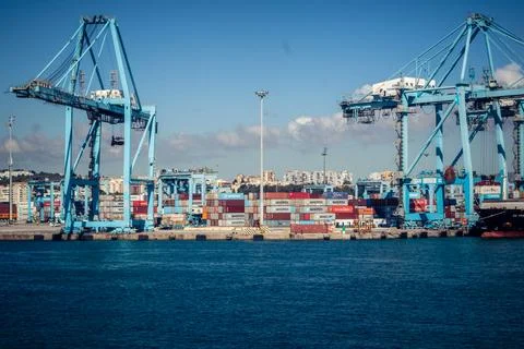 Large CMA CGM container ship unloading cargo under gantry cranes at port of.. Stock Photos