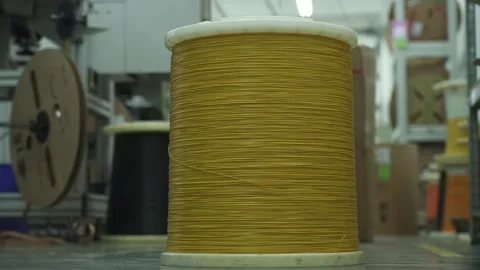 A large coil of cable being fed into a cable cutting machine Stock Footage 321896811
