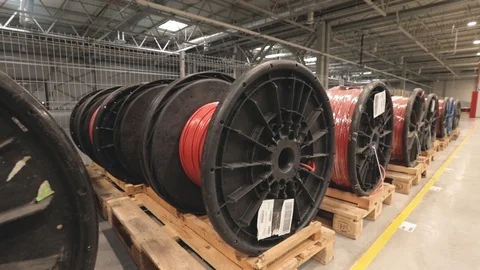 Large coils with red electrical wires on huge shelves in an industrial plant Stock Footage 120077614