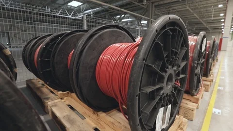 Large coils with red electrical wires on huge shelves in an industrial plant Stock Footage 123518515