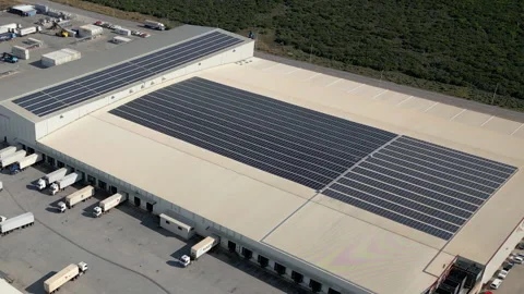Large cold storage port warehouse with massive rooftop solar array and Stock Footage 338027742