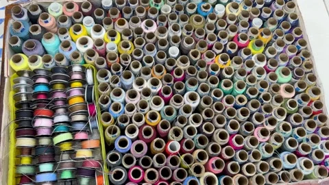 Large collection of colorful sewing thread spools neatly arranged in box ta.. Stock Footage 331796182