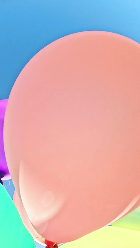 Large colorful balloons floating close up in clear summer sky Stock Footage 318439204