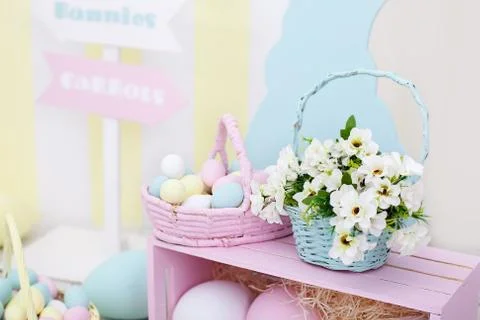 Large colorful baskets with Easter painted eggs and spring flowers. Stock Photos
