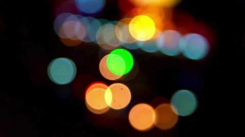 Large colorful bokeh light circles move in dark background Video stock 331990363