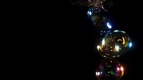 Large colorful bubbles on right side of frame shot in studio Video stock 77134423