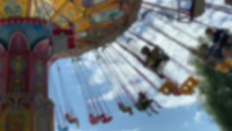 Large Colourful Carousel at the park on blue sky background. Blurred view. Stock Footage 167281609