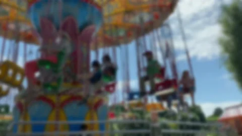 Large Colourful Carousel at the park on blue sky background. Blurred view. Stock Footage 167281611
