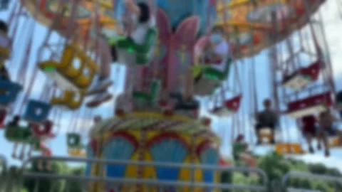 Large Colourful Carousel at the park on blue sky background. Blurred view. Stock Footage 167281620