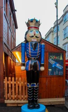 A large, colourful nutcracker statue dressed in a blue and red uniform Stock Photos