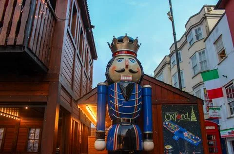 A large, colourful nutcracker statue dressed in a blue and red uniform Stock Photos