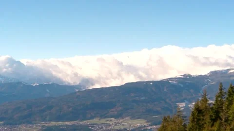 A large column of white fog rising to the sky, mountains and yellow-green Stock Footage 256433924