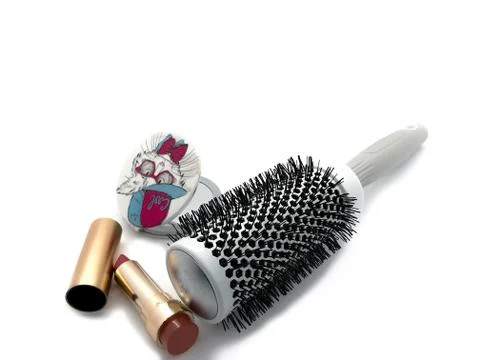 Large comb, a mirror with a pattern and lipstick isolated on a white background. Stock Photos