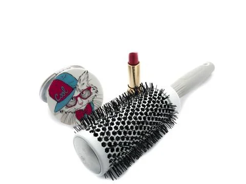 Large comb, a mirror with a pattern and lipstick isolated on a white background. Stock Photos