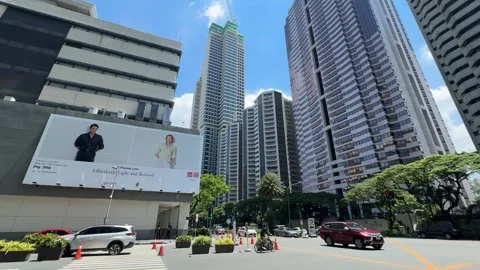 Large commercial billboard at city intersection with skyscraper skyline 4k Stock-Footage 337443511