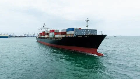 Large Commercial Container Ship Navigating Coastal Waters Toward Port Infra.. Stock Photos