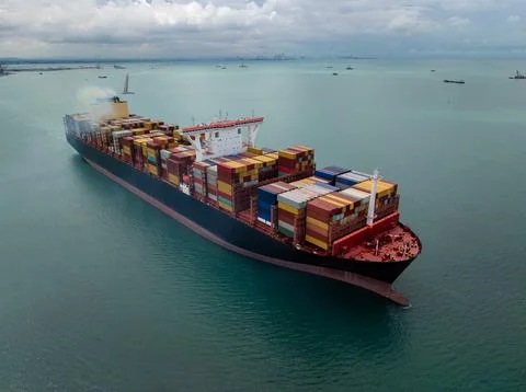 Large Commercial Container Ship Transporting Cargo Across The Open Sea In S.. Photos