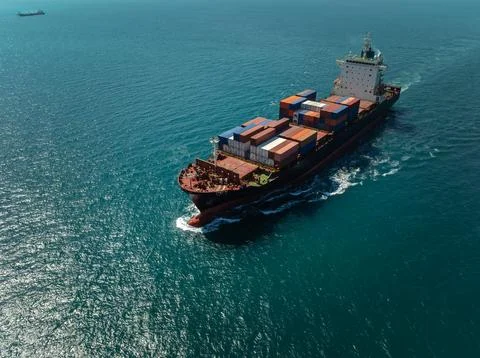 Large Commercial Container Ship Transporting Cargo Across Blue Ocean Wide Sho Stock Photos