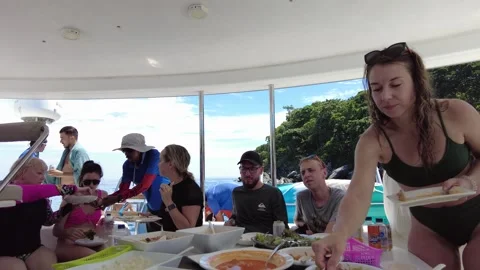 A large company has lunch while traveling on a yacht Stock Footage 258145695
