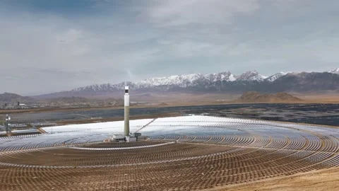 Large Concentrated Solar Power Plant with Heliostats and Snow Mountains China Stock Footage 346334691