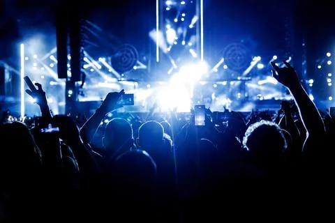Large concert hall filled with happy spectators before the stage Stock Photos