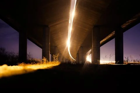Large concrete columns under the bridge at night Foto stock