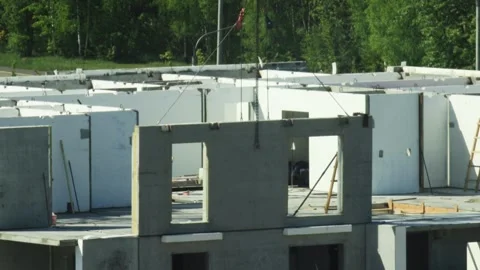 Large concrete wall panel with window openings hoisted by crane at construction Stock Footage 328359205